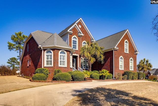 340 Heritage Forest Dr, Blythewood, SC 29045 - traditional-style house with brick siding, roof with shingles, and a front lawn