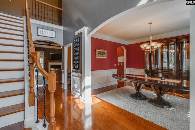 340 Heritage Forest Dr, Blythewood, SC 29045 - dining area featuring arched walkways, wood finished floors, stairway, crown molding, and a wainscoted wall