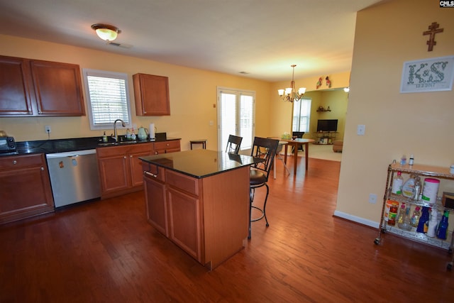 458 Laurel Mist Ln, West Columbia, SC 29170 - kitchen with stainless steel dishwasher, dark countertops, a chandelier, a kitchen breakfast bar, and dark wood-style flooring