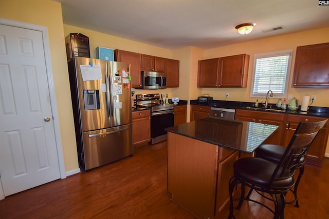 458 Laurel Mist Ln, West Columbia, SC 29170 - kitchen with appliances with stainless steel finishes, dark wood-type flooring, a kitchen breakfast bar, a kitchen island, and dark stone counters