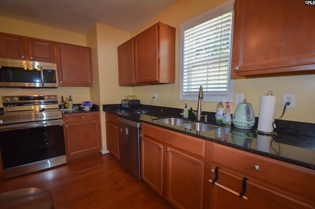 458 Laurel Mist Ln, West Columbia, SC 29170 - kitchen with appliances with stainless steel finishes, dark wood finished floors, dark stone counters, and brown cabinets