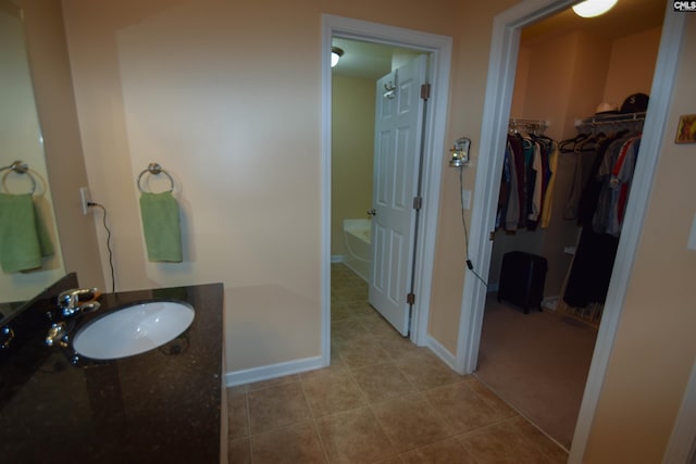 458 Laurel Mist Ln, West Columbia, SC 29170 - bathroom featuring a garden tub, vanity, tile patterned floors, and a walk in closet