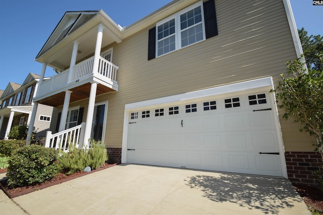 458 Laurel Mist Ln, West Columbia, SC 29170 - view of front of home featuring a balcony, brick siding, concrete driveway, and a garage