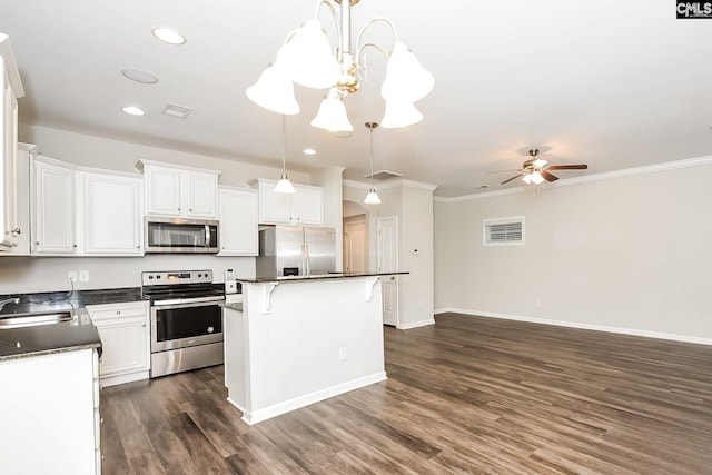779 Dawsons Park Way, Lexington, SC 29072 - kitchen with stainless steel appliances, dark countertops, ceiling fan, ornamental molding, and white cabinetry