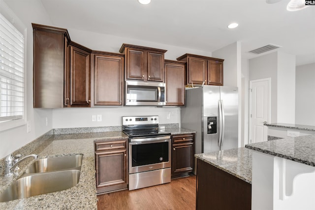 756 Dawsons Park Way, Lexington, SC 29072 - kitchen featuring stainless steel appliances, recessed lighting, wood finished floors, light stone counters, and dark brown cabinetry