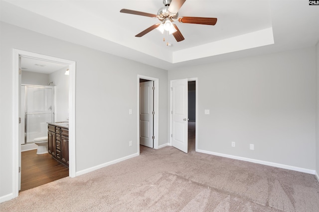 756 Dawsons Park Way, Lexington, SC 29072 - unfurnished bedroom featuring carpet, a tray ceiling, connected bathroom, and a ceiling fan