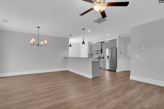 386 Amalfi Dr, Chapin, SC 29036 - unfurnished living room featuring a chandelier, ornamental molding, recessed lighting, ceiling fan, and light wood-type flooring