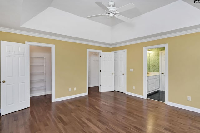 256 Sheringham Rd, Columbia, SC 29212 - unfurnished bedroom with a spacious closet, dark wood-style flooring, a tray ceiling, crown molding, and ensuite bathroom