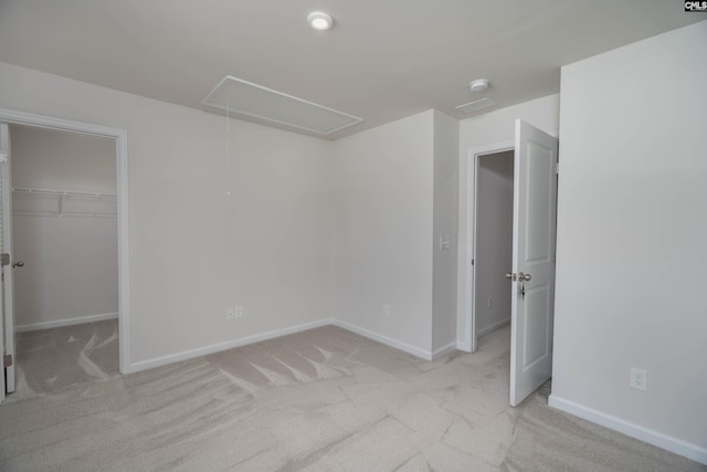 1021 Bermuda Cedar Ln, Hopkins, SC 29061 - unfurnished bedroom featuring attic access, light carpet, a walk in closet, and a closet