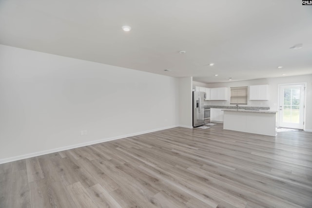 1021 Bermuda Cedar Ln, Hopkins, SC 29061 - unfurnished living room with light wood-style floors and recessed lighting