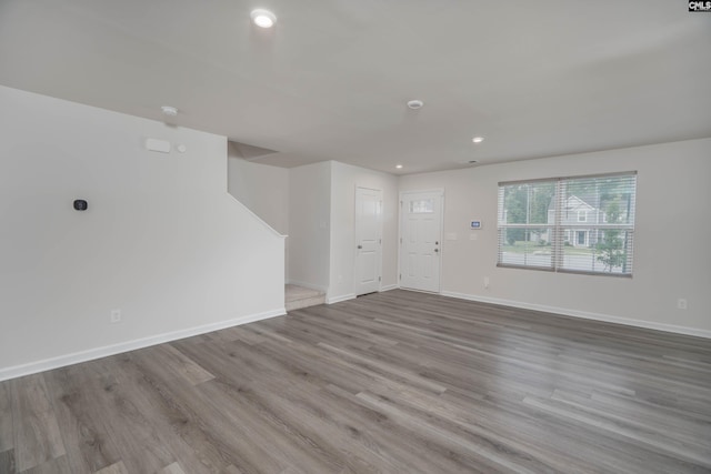 1021 Bermuda Cedar Ln, Hopkins, SC 29061 - unfurnished living room featuring recessed lighting, wood finished floors, and stairs