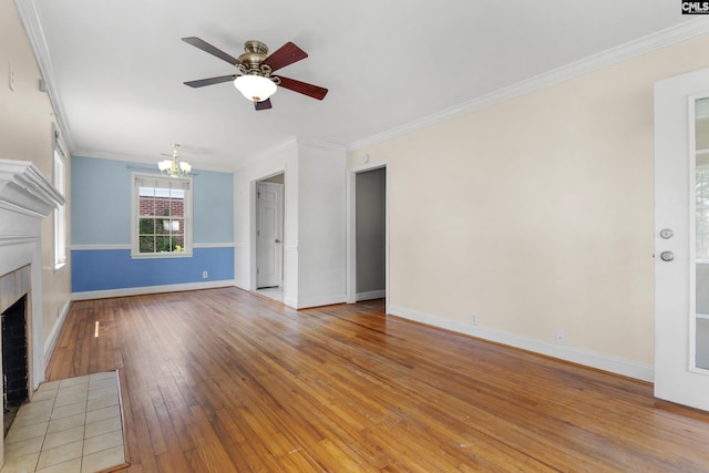 1400 Axtell Dr, Cayce, SC 29033 - unfurnished living room with a chandelier, a tiled fireplace, a ceiling fan, ornamental molding, and hardwood / wood-style floors