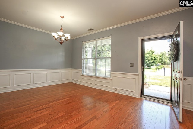 418 Abbeydale Way, Columbia, SC 29229 - empty room featuring a chandelier, wood finished floors, crown molding, and a wainscoted wall