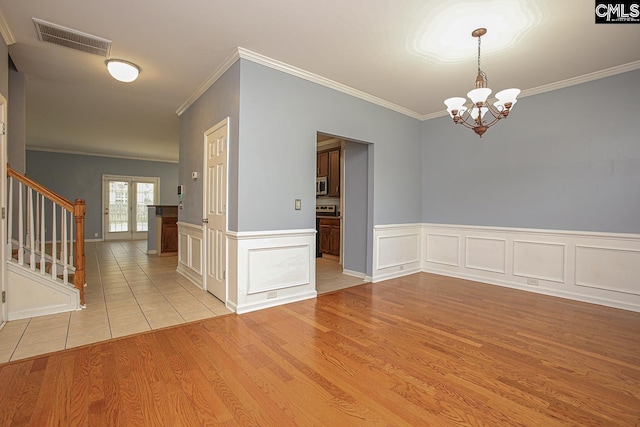 418 Abbeydale Way, Columbia, SC 29229 - unfurnished room featuring crown molding, stairway, a chandelier, light wood finished floors, and a wainscoted wall