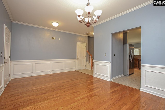 418 Abbeydale Way, Columbia, SC 29229 - spare room with crown molding, wood finished floors, a chandelier, wainscoting, and stairs