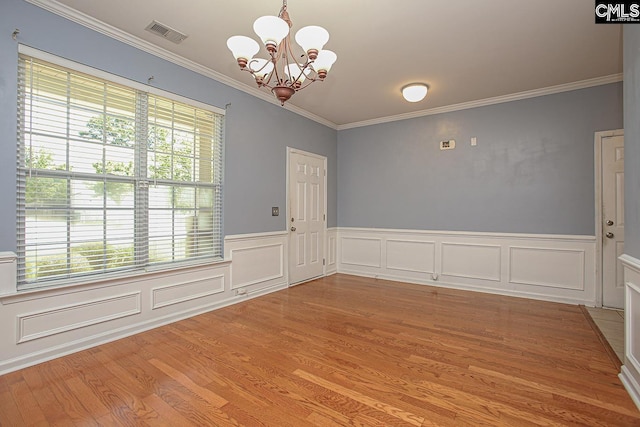 418 Abbeydale Way, Columbia, SC 29229 - unfurnished dining area with crown molding, plenty of natural light, a chandelier, light wood-style floors, and a wainscoted wall