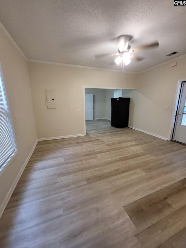 337 Mill St, Batesburg, SC 29006 - unfurnished living room with ornamental molding, ceiling fan, a textured ceiling, light wood-style floors, and electric panel