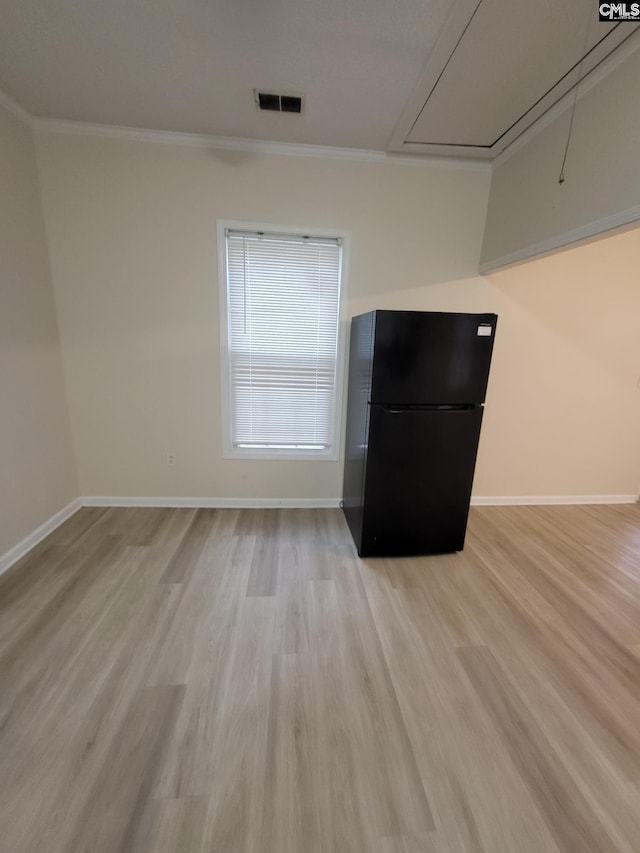 337 Mill St, Batesburg, SC 29006 - unfurnished living room with attic access, light wood-style floors, and crown molding