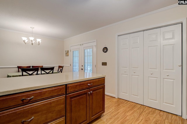 122 Halling Dr, Columbia, SC 29229 - kitchen featuring ornamental molding, light wood finished floors, light countertops, a chandelier, and pendant lighting