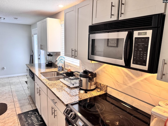 407 N Donar Dr, Columbia, SC 29229 - kitchen featuring black electric range oven, light marble finish floors, light stone counters, tasteful backsplash, and a textured ceiling