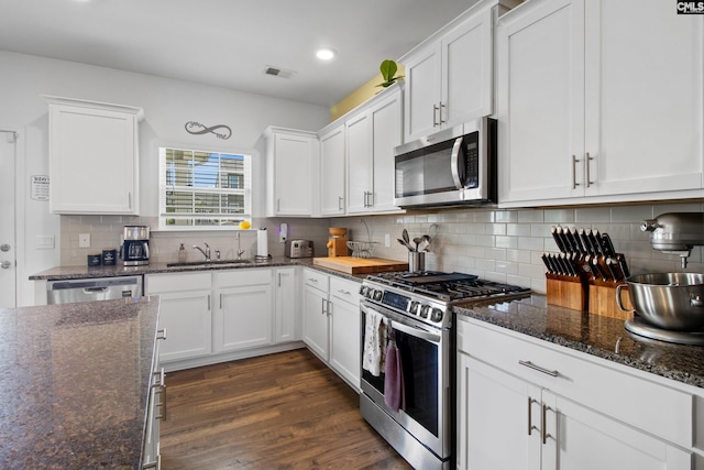 1420 Fair Forest Ln, Chapin, SC 29036 - kitchen featuring stainless steel appliances, white cabinetry, dark wood finished floors, and recessed lighting