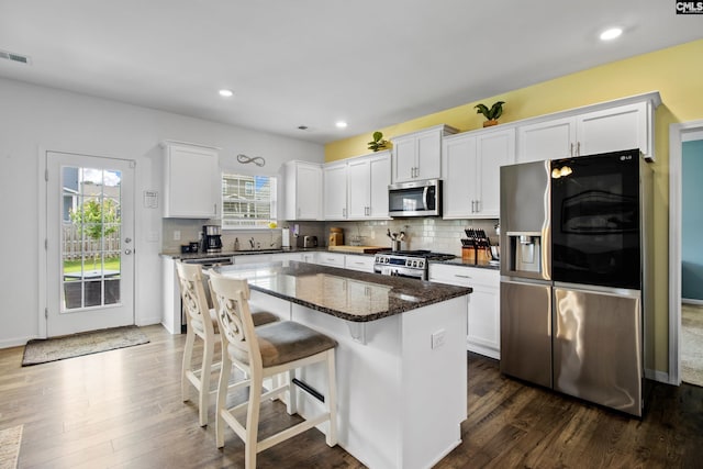 1420 Fair Forest Ln, Chapin, SC 29036 - kitchen with appliances with stainless steel finishes, white cabinets, a center island, dark wood-style flooring, and recessed lighting