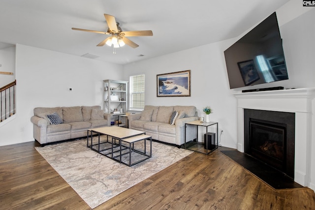 1420 Fair Forest Ln, Chapin, SC 29036 - living room with dark wood-style floors, ceiling fan, stairway, and a glass covered fireplace
