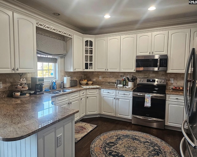 115 Lake Hilton Dr, Chapin, SC 29036 - kitchen featuring stainless steel appliances, white cabinetry, a peninsula, tasteful backsplash, and glass insert cabinets