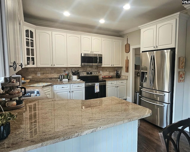 115 Lake Hilton Dr, Chapin, SC 29036 - kitchen featuring appliances with stainless steel finishes, glass insert cabinets, light stone counters, white cabinetry, and crown molding