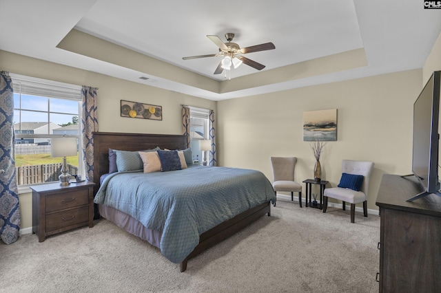 345 Wahoo Cir, Irmo, SC 29063 - bedroom featuring a tray ceiling, light colored carpet, and a ceiling fan
