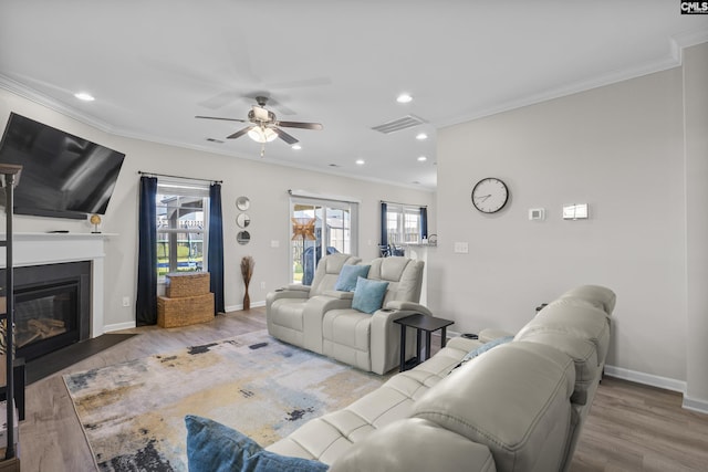 345 Wahoo Cir, Irmo, SC 29063 - living area featuring crown molding, a ceiling fan, wood finished floors, a fireplace with flush hearth, and recessed lighting