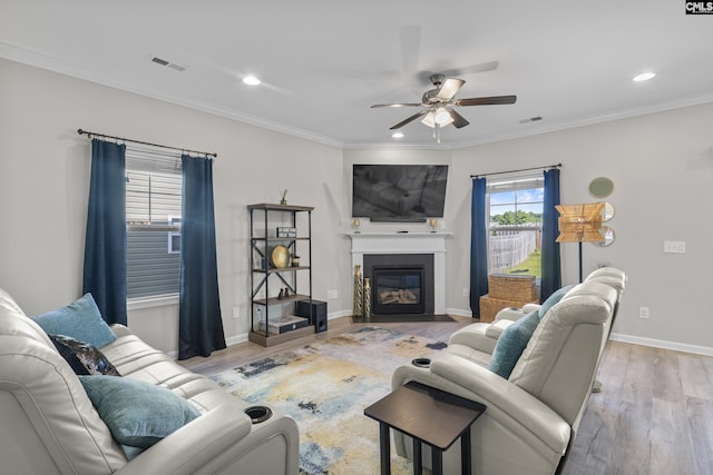 345 Wahoo Cir, Irmo, SC 29063 - living area featuring a ceiling fan, wood finished floors, a fireplace with flush hearth, ornamental molding, and recessed lighting