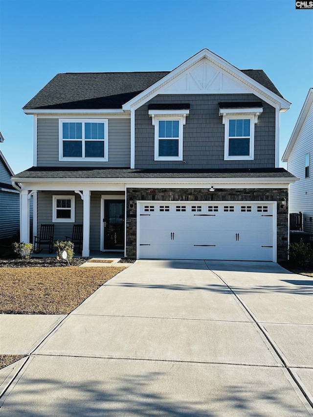 1013 Ashcroft Cir, Columbia, SC 29229 - view of front of property with concrete driveway, a porch, a garage, and stone siding