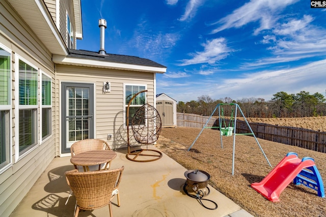1013 Ashcroft Cir, Columbia, SC 29229 - fenced backyard featuring a playground, a storage shed, and a patio