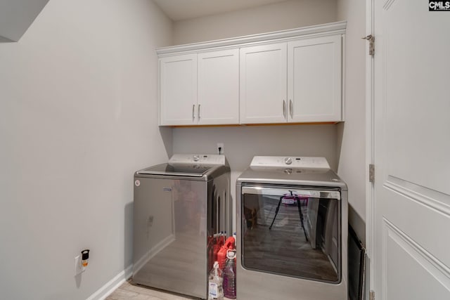 1013 Ashcroft Cir, Columbia, SC 29229 - laundry room featuring cabinet space, independent washer and dryer, and light wood-style floors