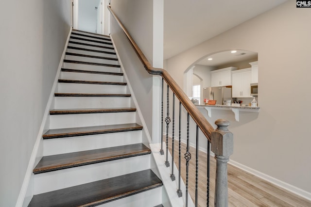 1013 Ashcroft Cir, Columbia, SC 29229 - staircase with wood finished floors, arched walkways, and recessed lighting
