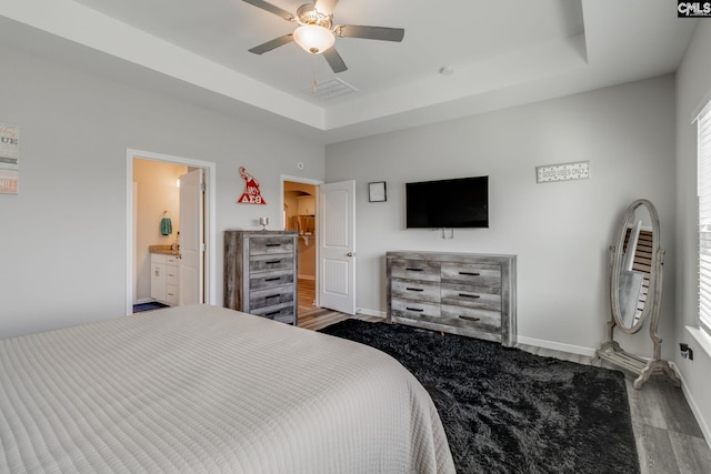 1013 Ashcroft Cir, Columbia, SC 29229 - bedroom with a tray ceiling, wood finished floors, a ceiling fan, and ensuite bathroom