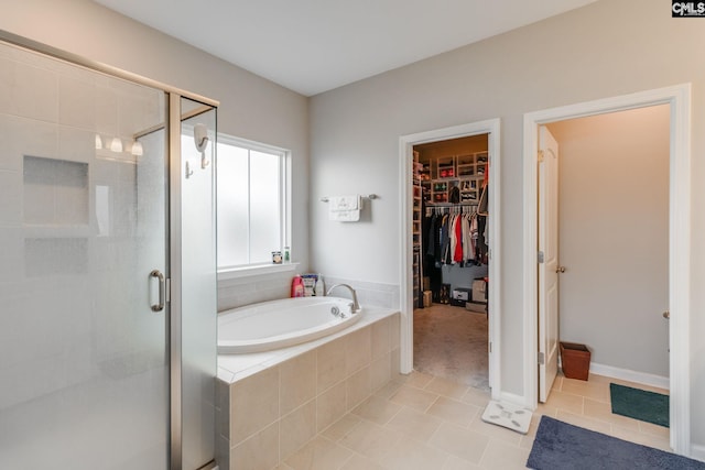 1013 Ashcroft Cir, Columbia, SC 29229 - full bathroom with tile patterned flooring, a shower stall, a garden tub, and a spacious closet