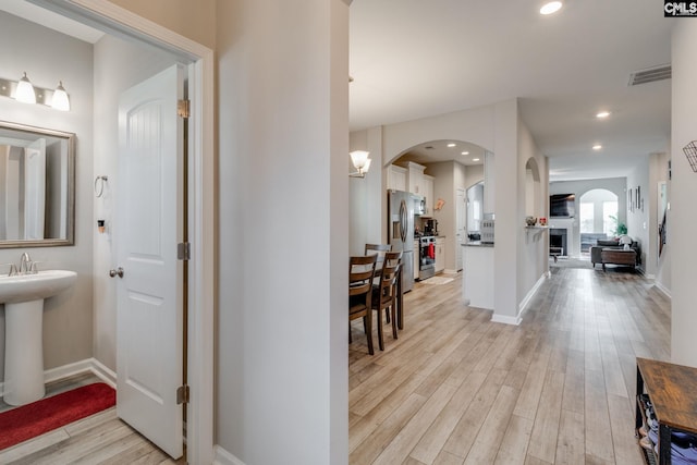 1013 Ashcroft Cir, Columbia, SC 29229 - hall with arched walkways, light wood finished floors, and recessed lighting
