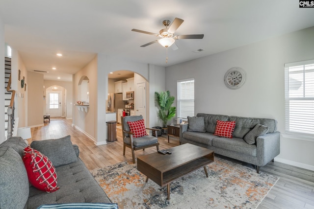 1013 Ashcroft Cir, Columbia, SC 29229 - living room with arched walkways, light wood-type flooring, a ceiling fan, recessed lighting, and stairway