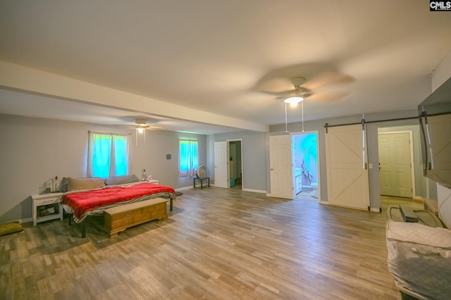 1206 Furman Dr, Sumter, SC 29154 - bedroom featuring a barn door, wood finished floors, and ceiling fan
