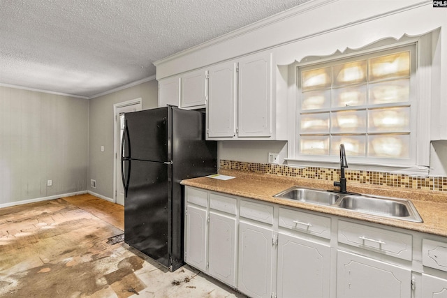 247 Piney Grove Rd, Columbia, SC 29210 - kitchen featuring freestanding refrigerator, a textured ceiling, white cabinets, crown molding, and tasteful backsplash