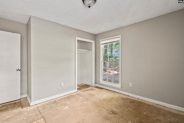 247 Piney Grove Rd, Columbia, SC 29210 - unfurnished bedroom with concrete floors, a closet, and a textured ceiling