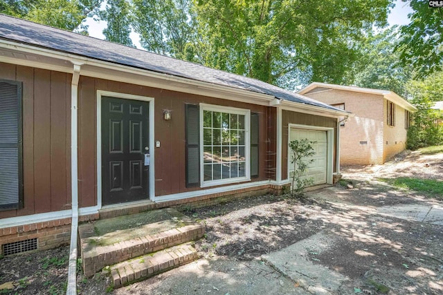 247 Piney Grove Rd, Columbia, SC 29210 - view of exterior entry featuring an attached garage, a shingled roof, driveway, and crawl space