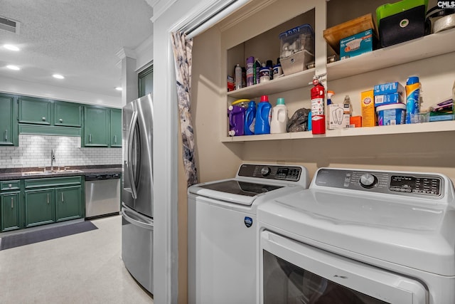 108 Sawgrass Ct, West Columbia, SC 29172 - laundry room with washing machine and clothes dryer, a textured ceiling, and recessed lighting