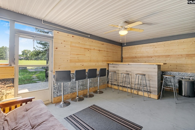 108 Sawgrass Ct, West Columbia, SC 29172 - miscellaneous room with concrete floors, wooden walls, a ceiling fan, and a bar