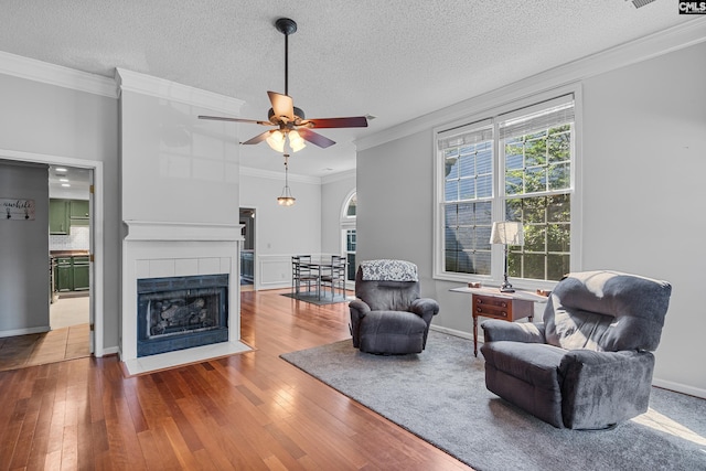 108 Sawgrass Ct, West Columbia, SC 29172 - living area with ornamental molding, hardwood / wood-style floors, ceiling fan, a tiled fireplace, and a textured ceiling