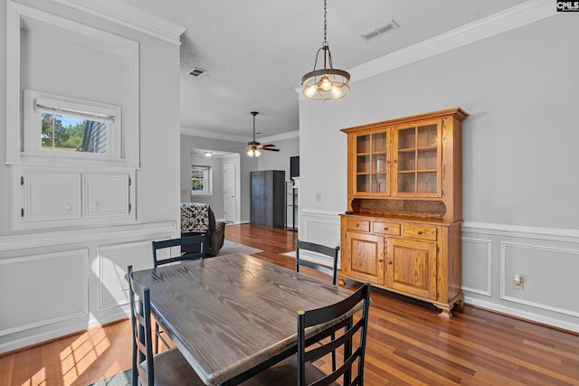 108 Sawgrass Ct, West Columbia, SC 29172 - dining room featuring dark wood-type flooring, a decorative wall, a ceiling fan, crown molding, and a textured ceiling