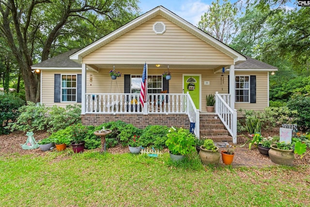 151 Thornridge Rd, Wagener, SC 29164 - bungalow-style home with a porch, a front yard, and roof with shingles