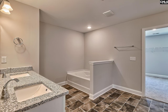 689 W Columbia Ave, Batesburg, SC 29006 - bathroom with a bath, double vanity, and a walk in closet